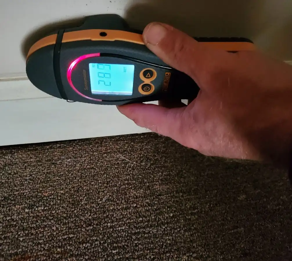 Moisture detection at baseboard during Storm Damage Restoration in Belfast